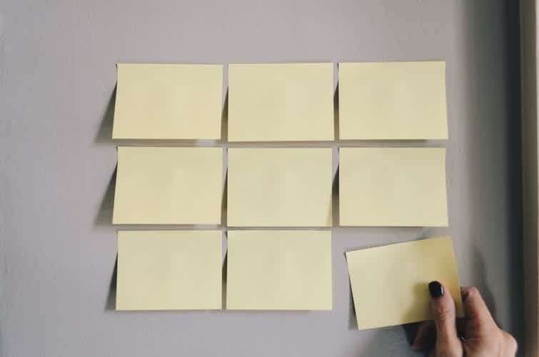 Image of 9 post it notes on a wall 