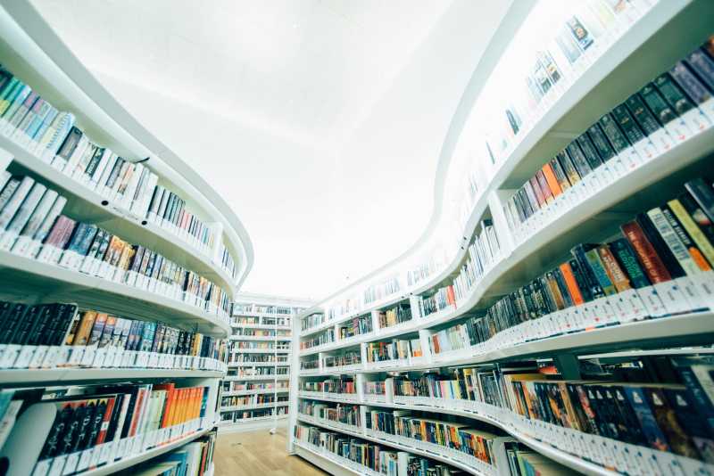 An image of shelves in a library filled with books