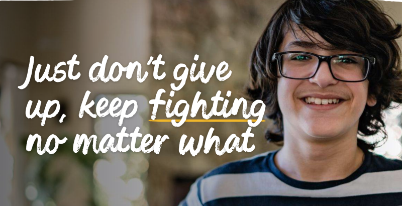 A screenshot of the homepage for The Children's Society showing a boy smiling and the words 'Just don't give up, keep fighting no matter what'