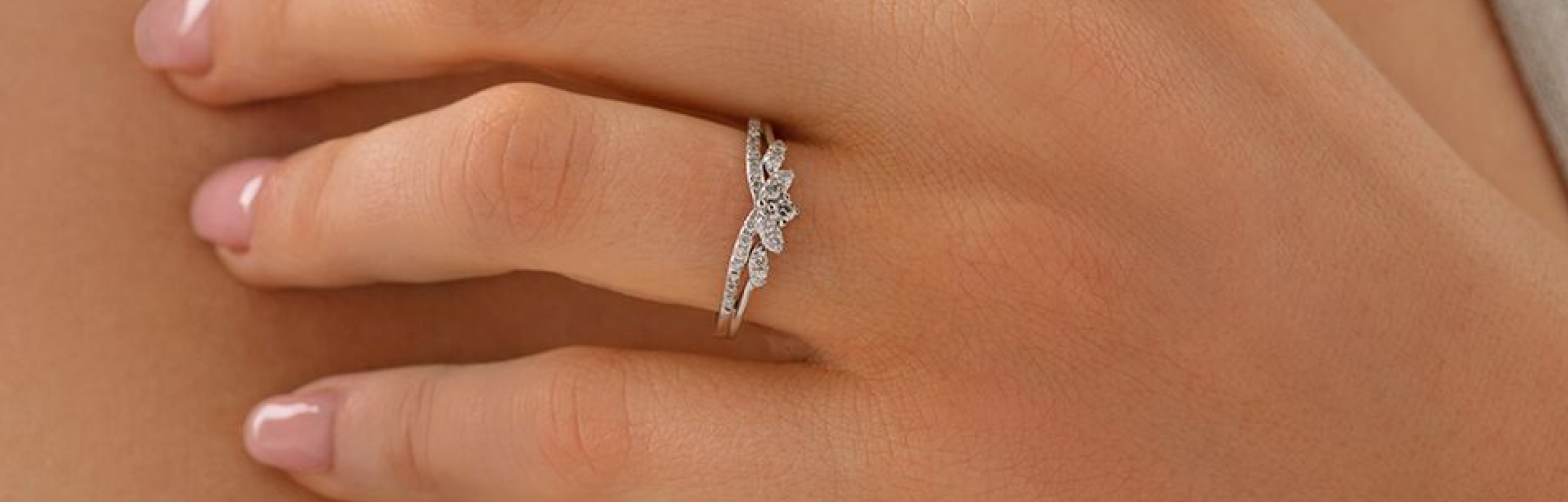 white gold vintage inspired engagement ring on womans hand