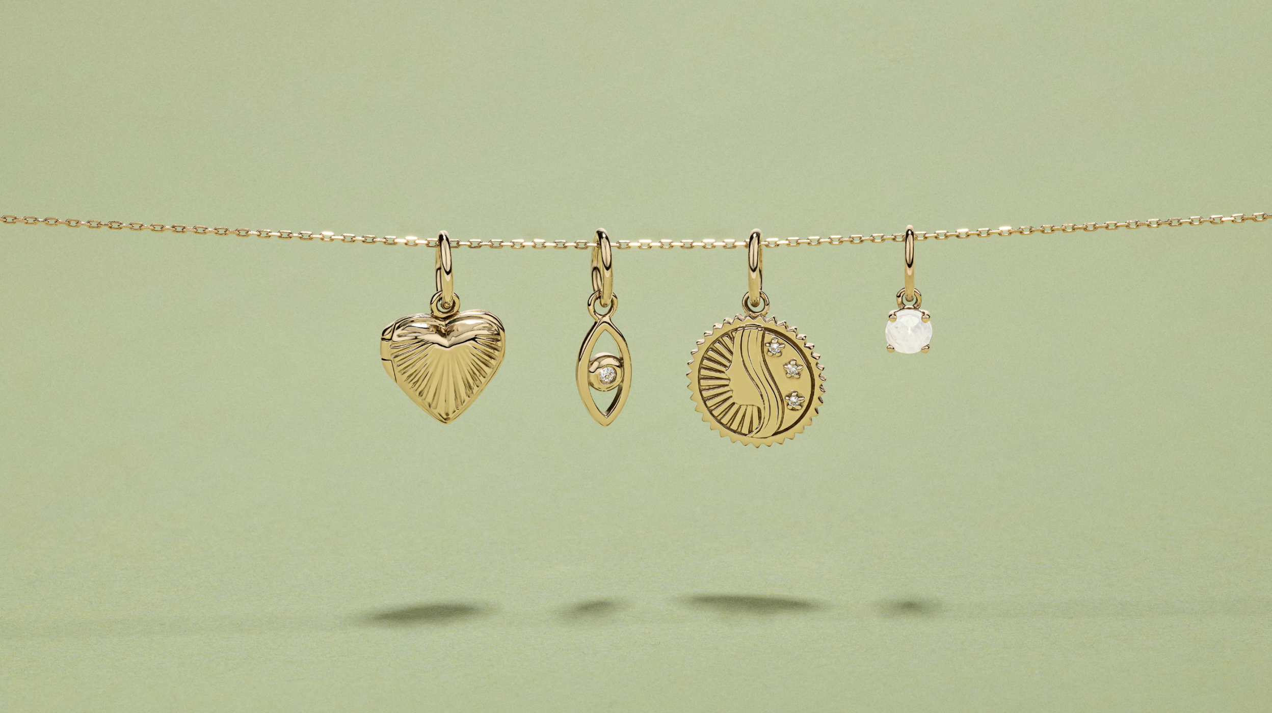  Flatlay of four mixed pendants hanging from a slide on chain