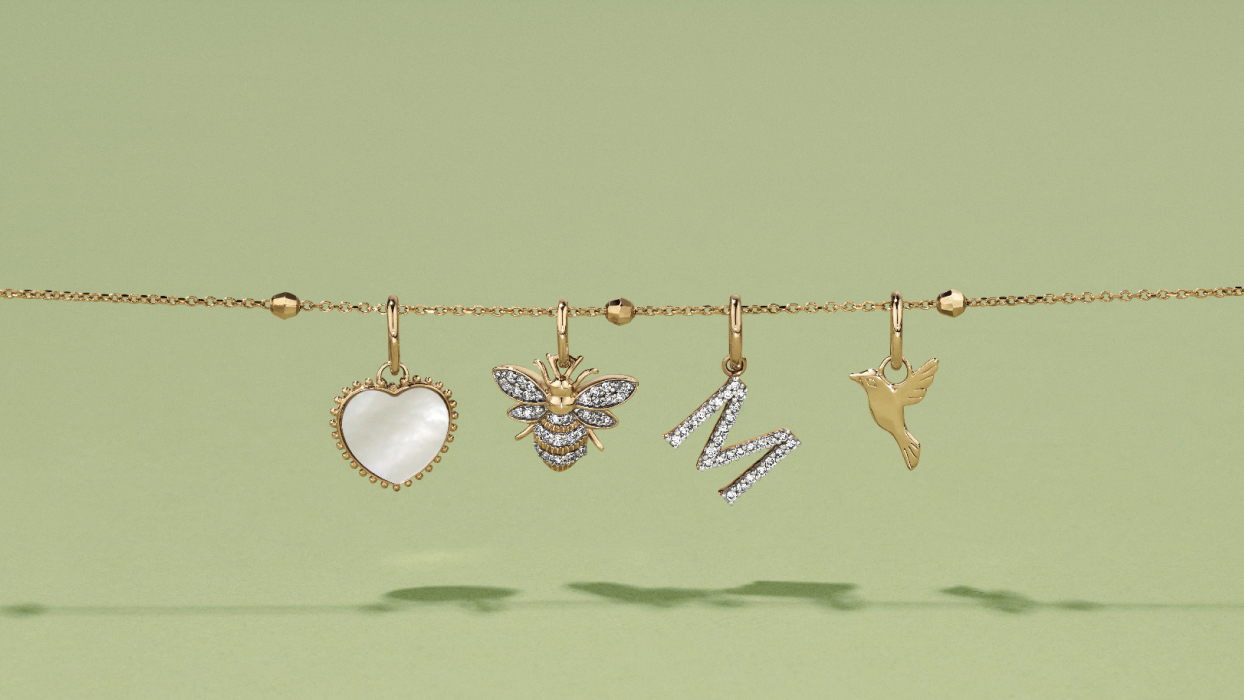  Flatlay of four mixed pendants hanging from a slide on chain