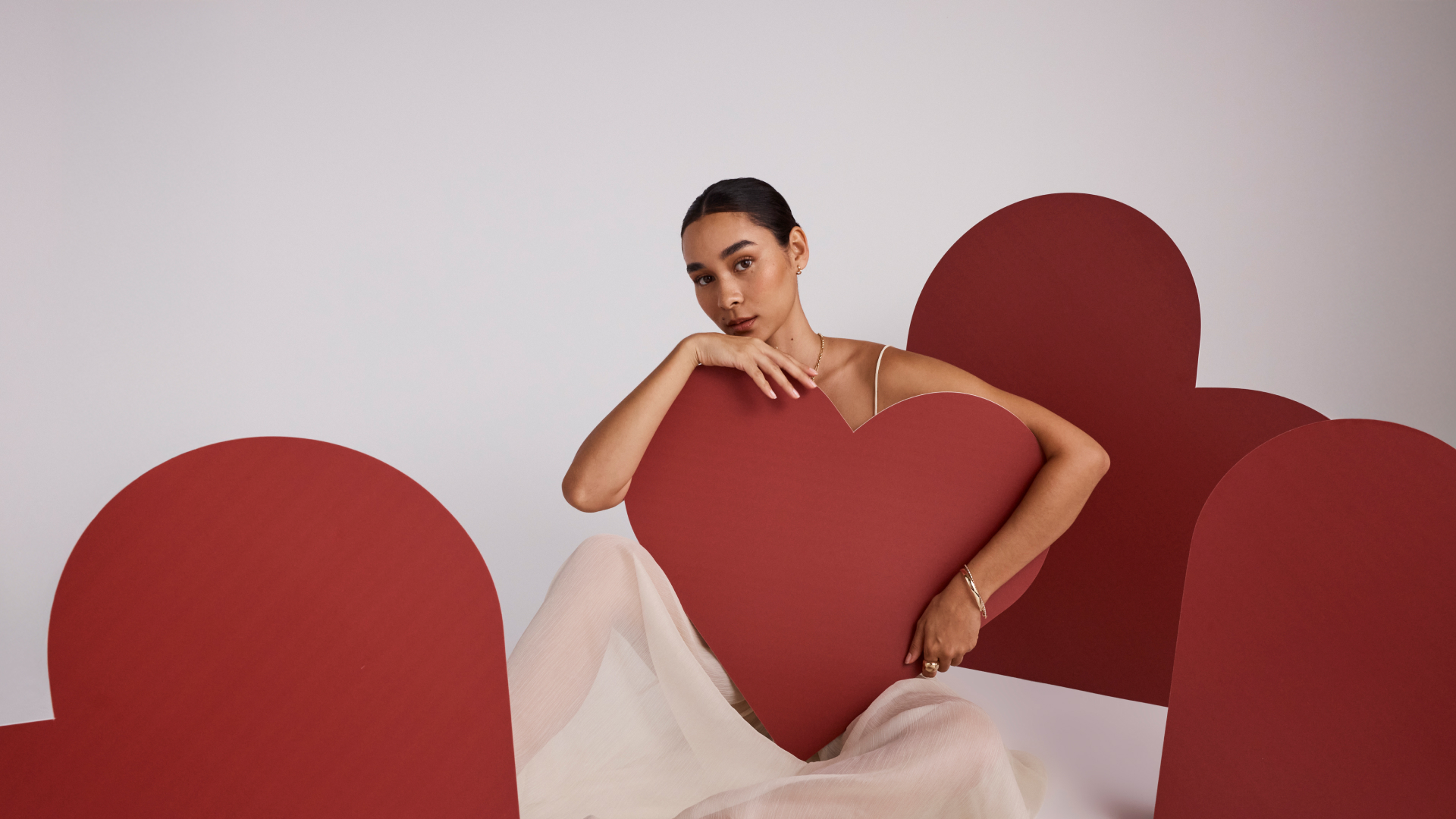 Michael Hill model wearing jewellery posing with hearts