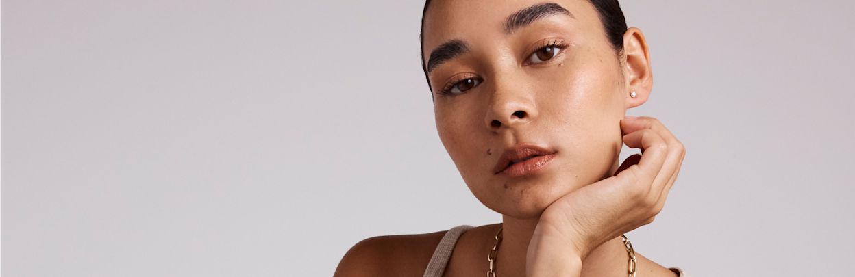 model wearing tennis bracelet and gold bangle