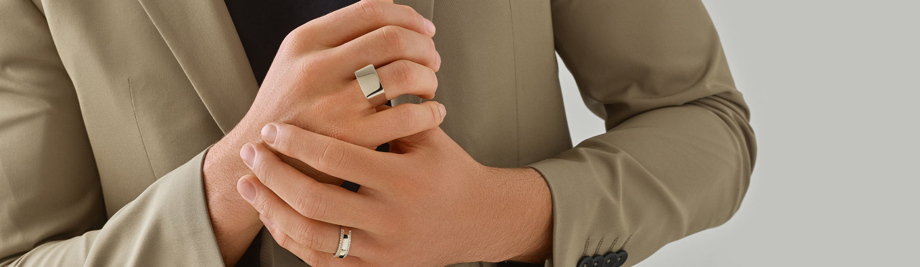 mens rings in gold and platinum on mans hands