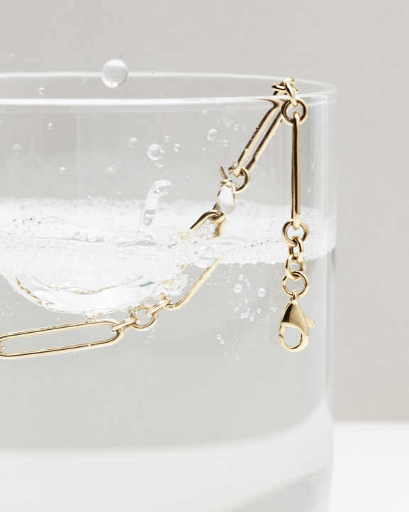 gold huggie hoop earring flat lay