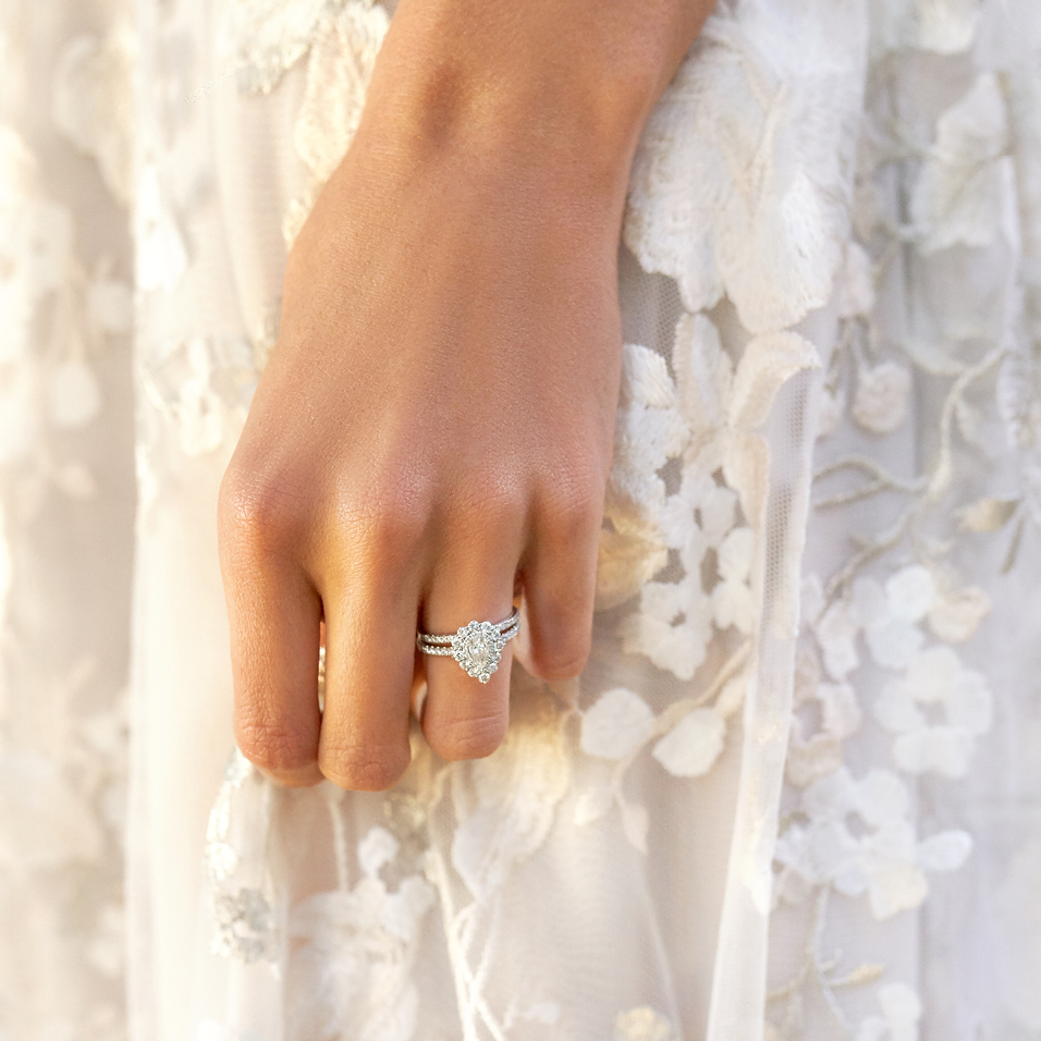 Bride wearing michael hill engagement ring in floral dress