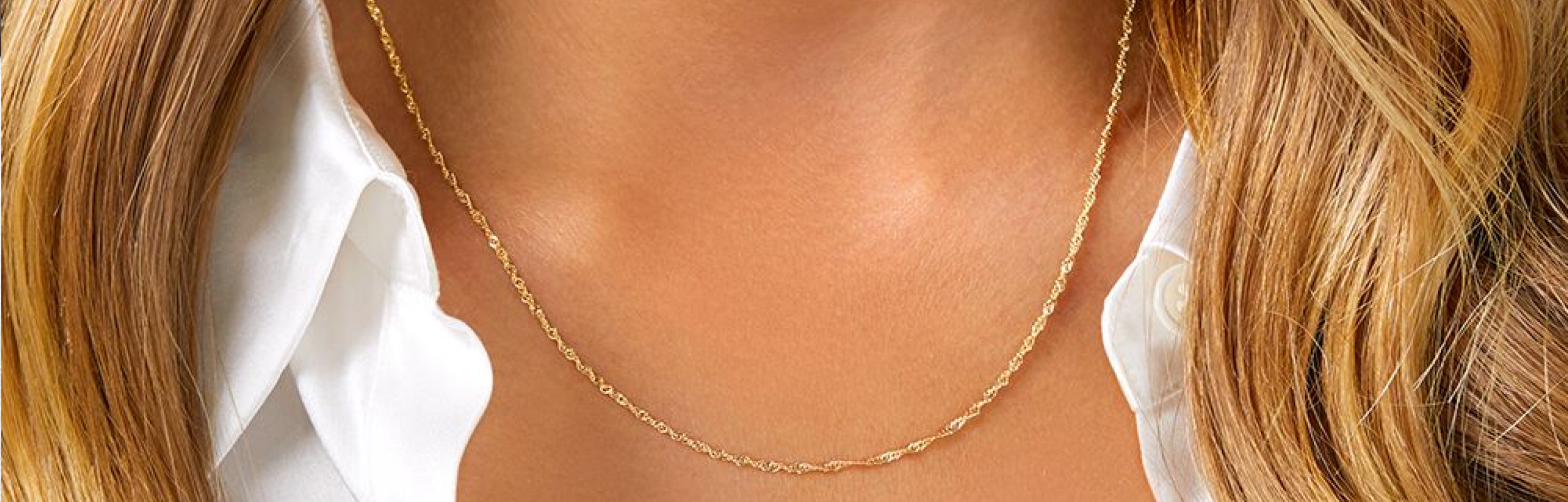 gold singapore chain worn by woman