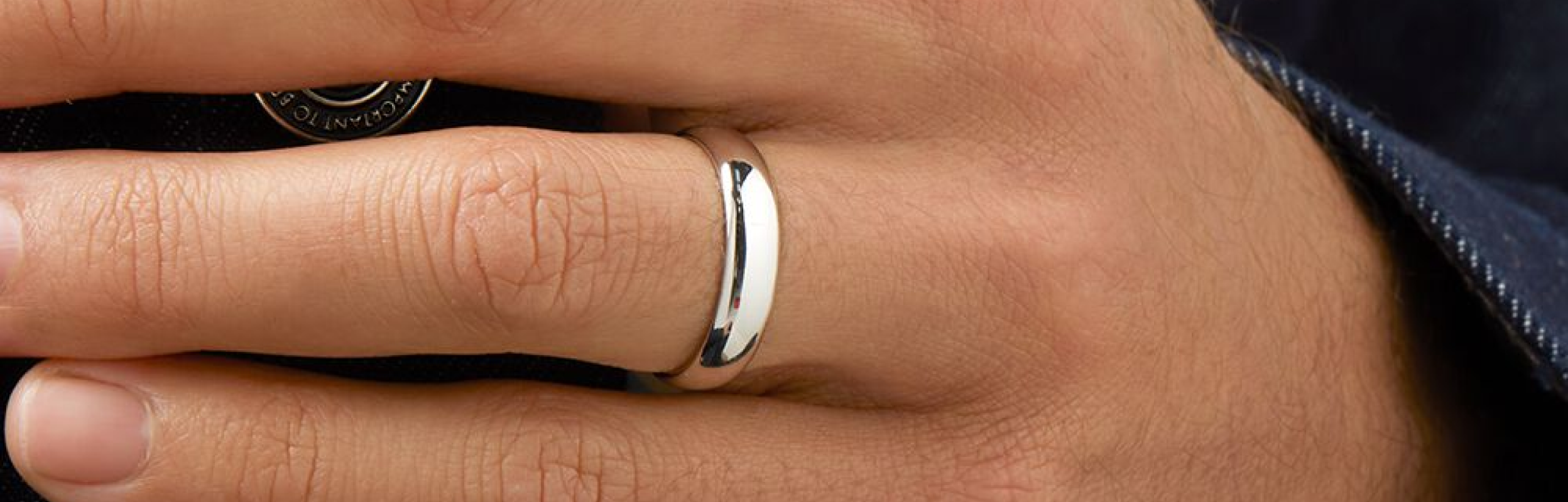 white gold wedding ring on mands hand