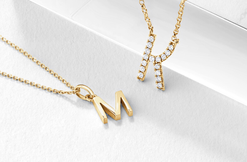 Gold layered necklces with A and M inital
