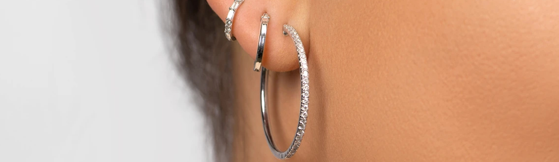Woman wearing diamond hoop earrings