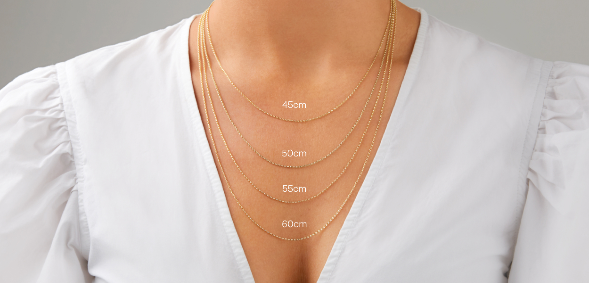 necklace length chart with person person wearing 4 gold chains showing how each measurement length looks