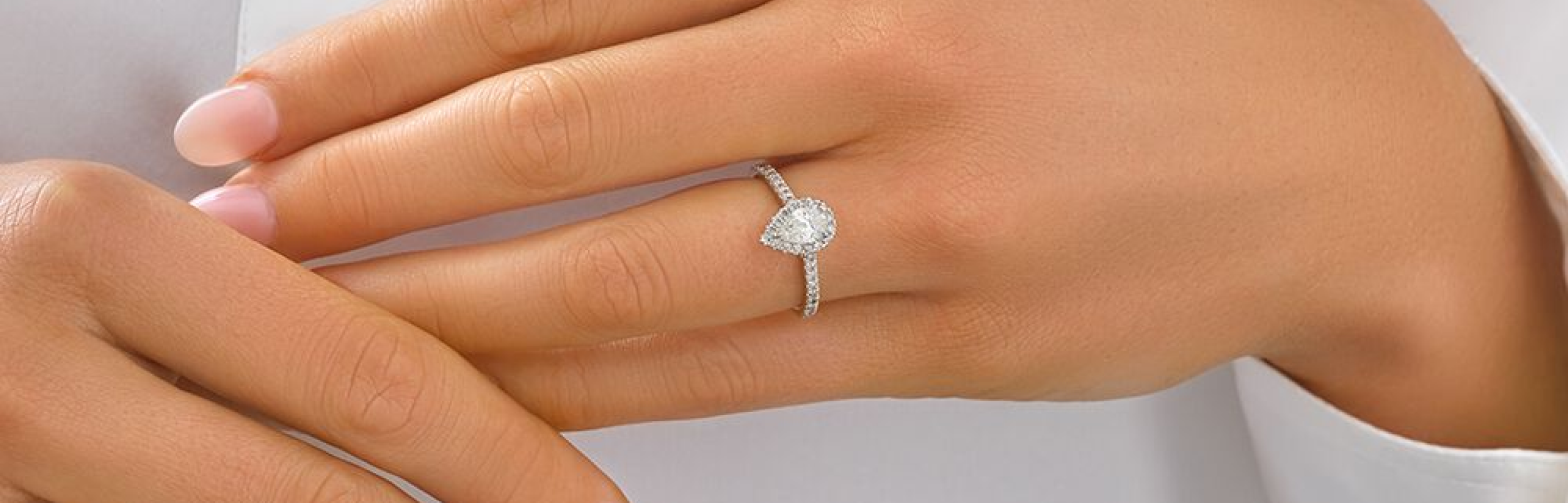 pear cut diamond engagement ring with diamond halo