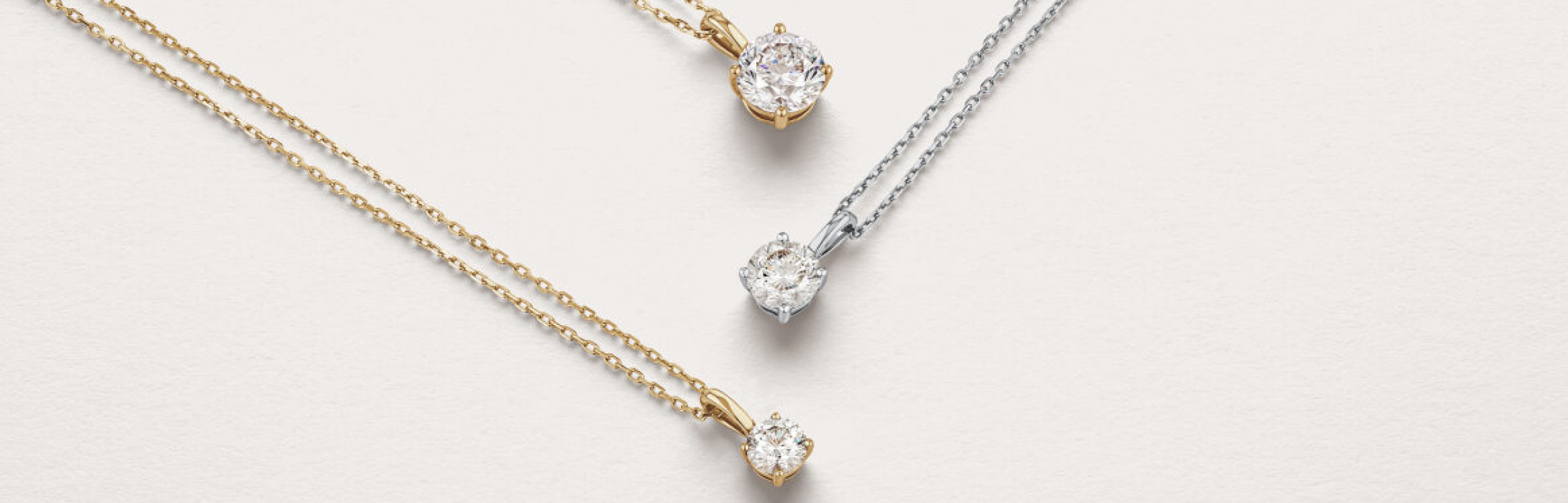 signature diamond solitaire pendants in yellow and white gold