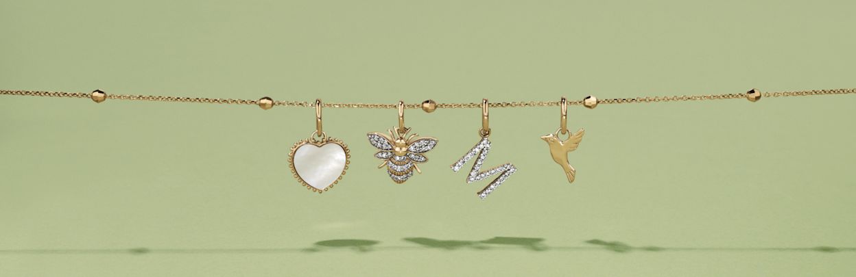  Flatlay of four mixed pendants hanging from a slide on chain