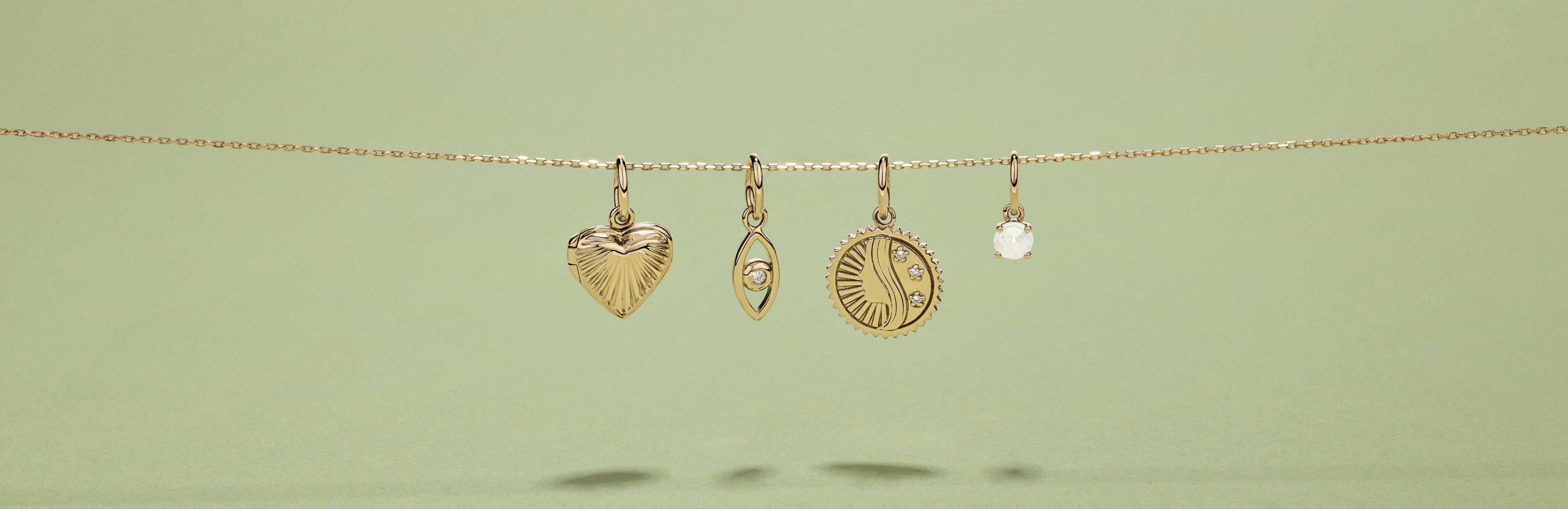 Flatlay of four mixed pendants hanging from a slide on chain