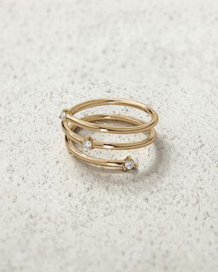 triple twist gold ring with three diamonds