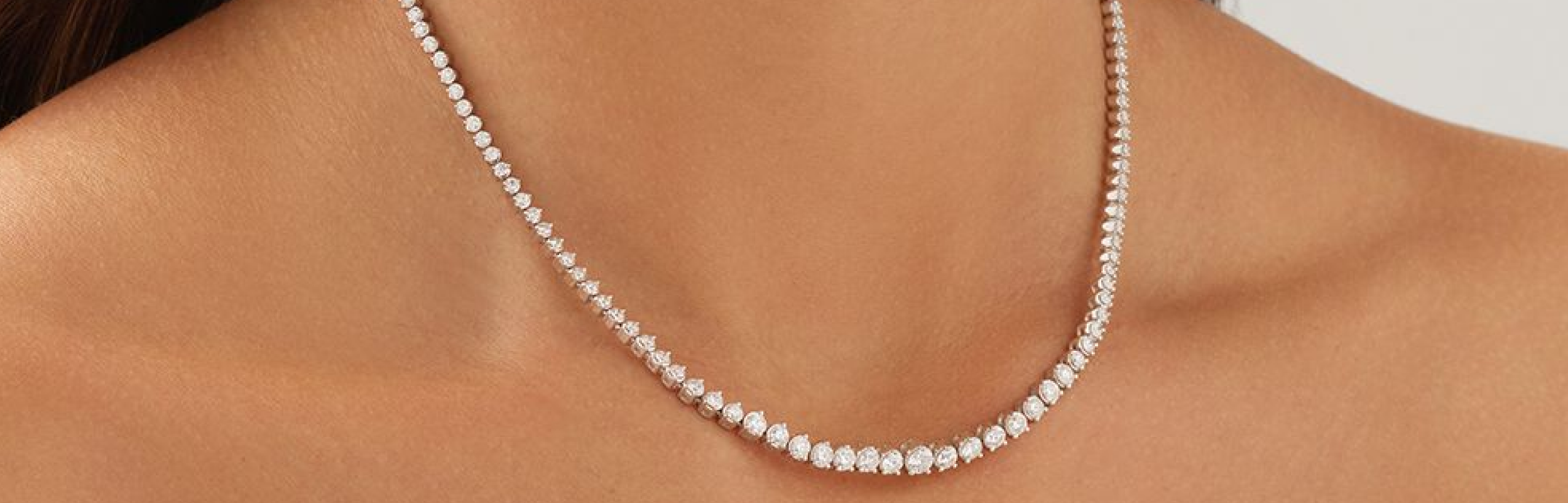 diamond tennis necklace on womans neck