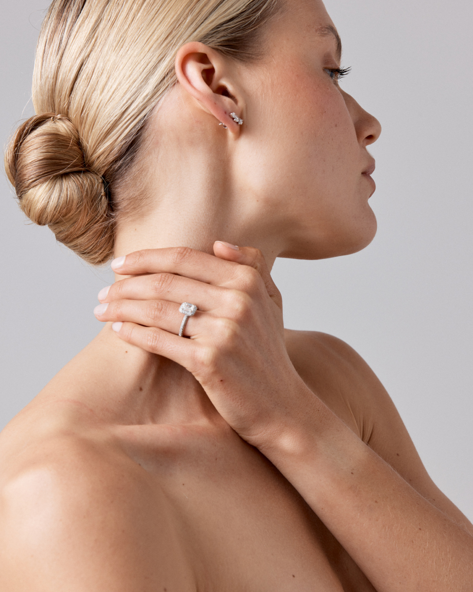 woman wearing emerald cut diamond engagement ring