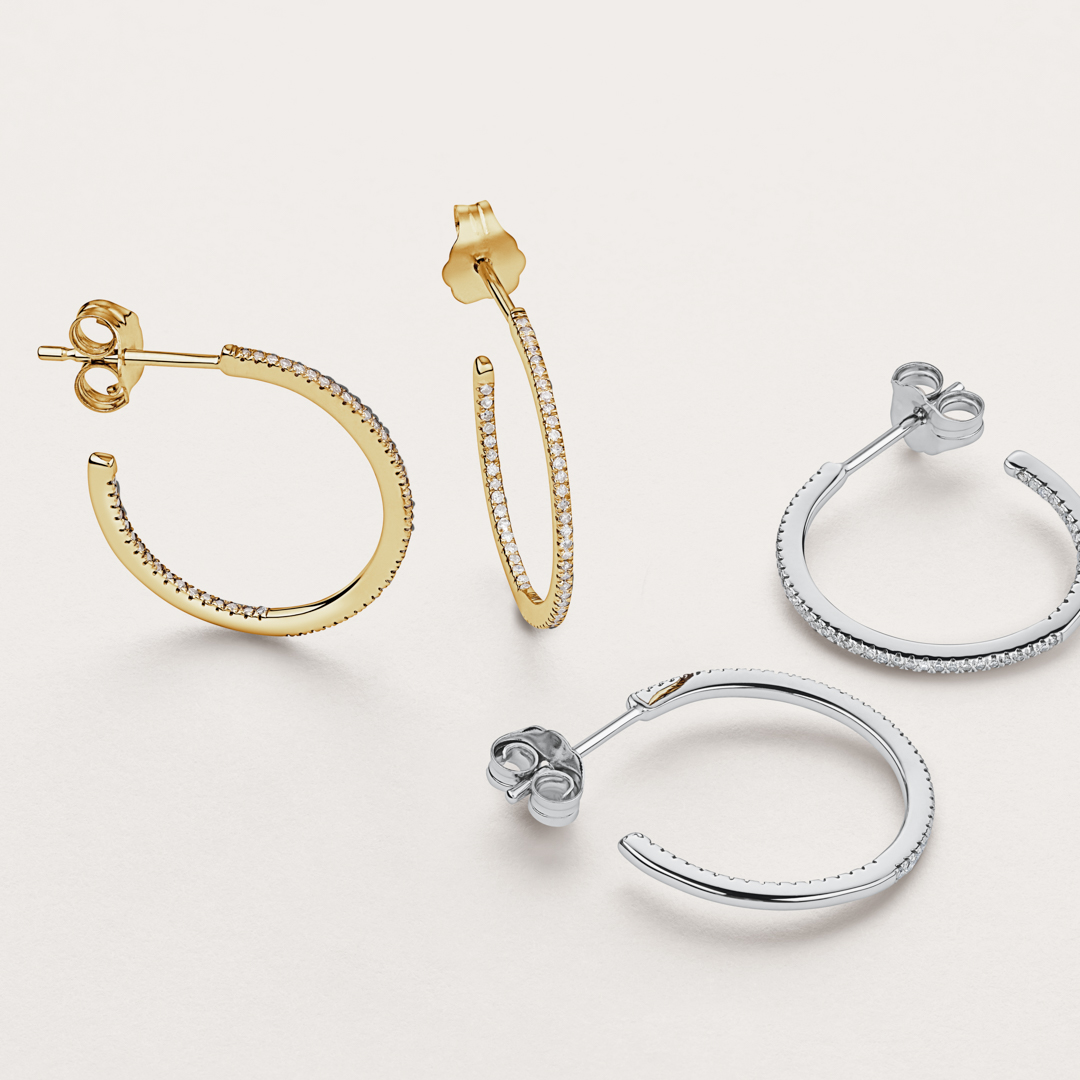 Flatlay of yellow gold and diamond earrings