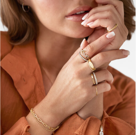 Multiple stacker gold rings, love ring with diamonds and gold link bracelets