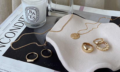 Beautiful gold jewellery spread out on side table