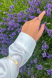 Amethyst Ring and Heart Bracelet on arm amongst Lavender flowers