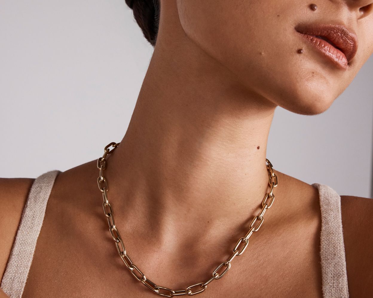Model wearing gold chunky paperclip necklace