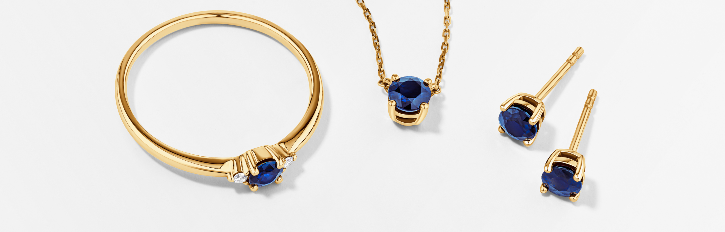 Sapphire jewellery, ring, necklace and earrings in yellow gold