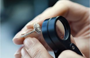 Pear shape engagement ring being looked at underneath a microscope