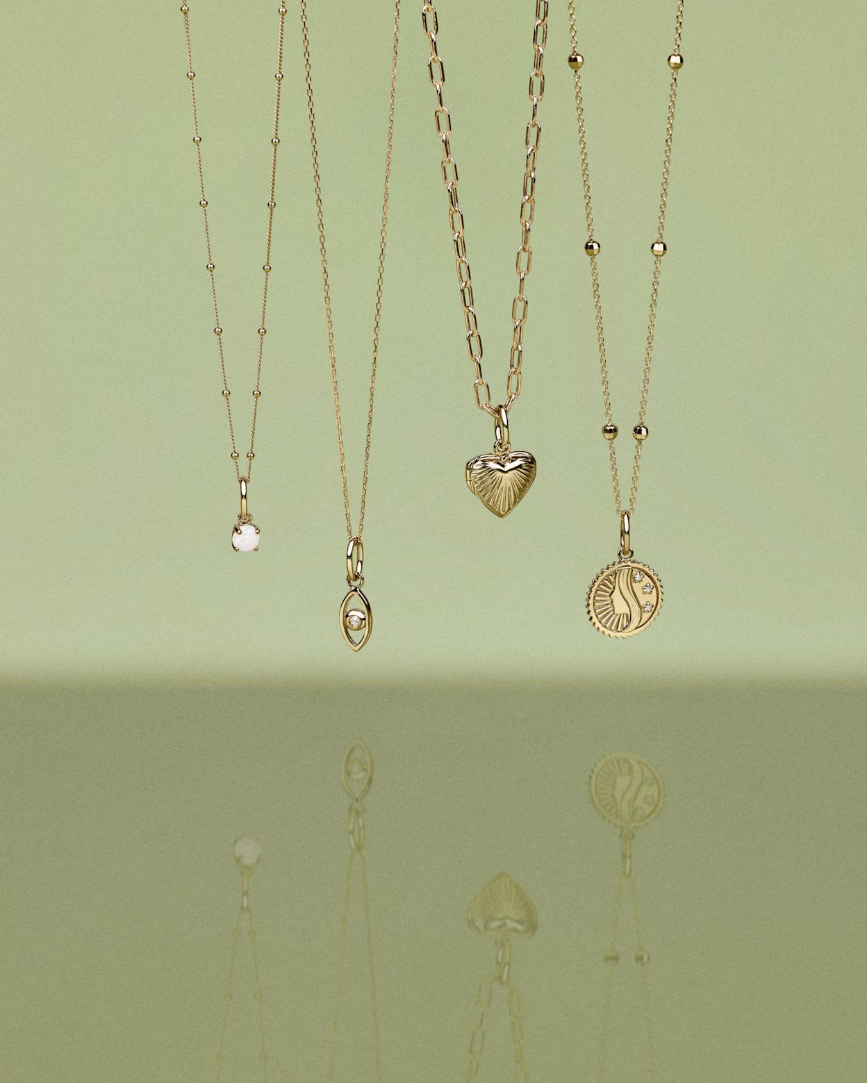 Close up of model wearing an open chain necklace and connector with mixed pendants 