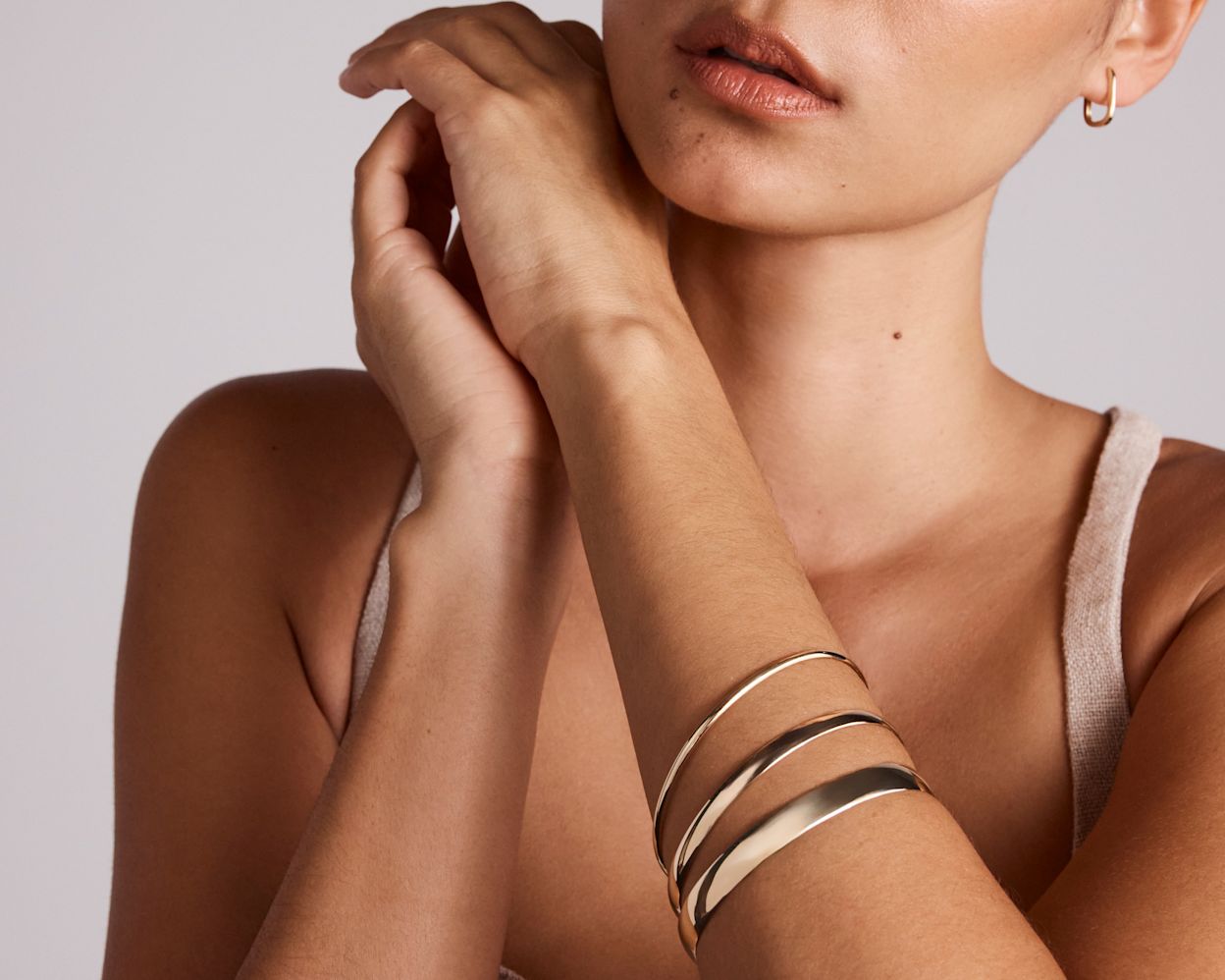 model wearing gold bangle and tennis bracelets