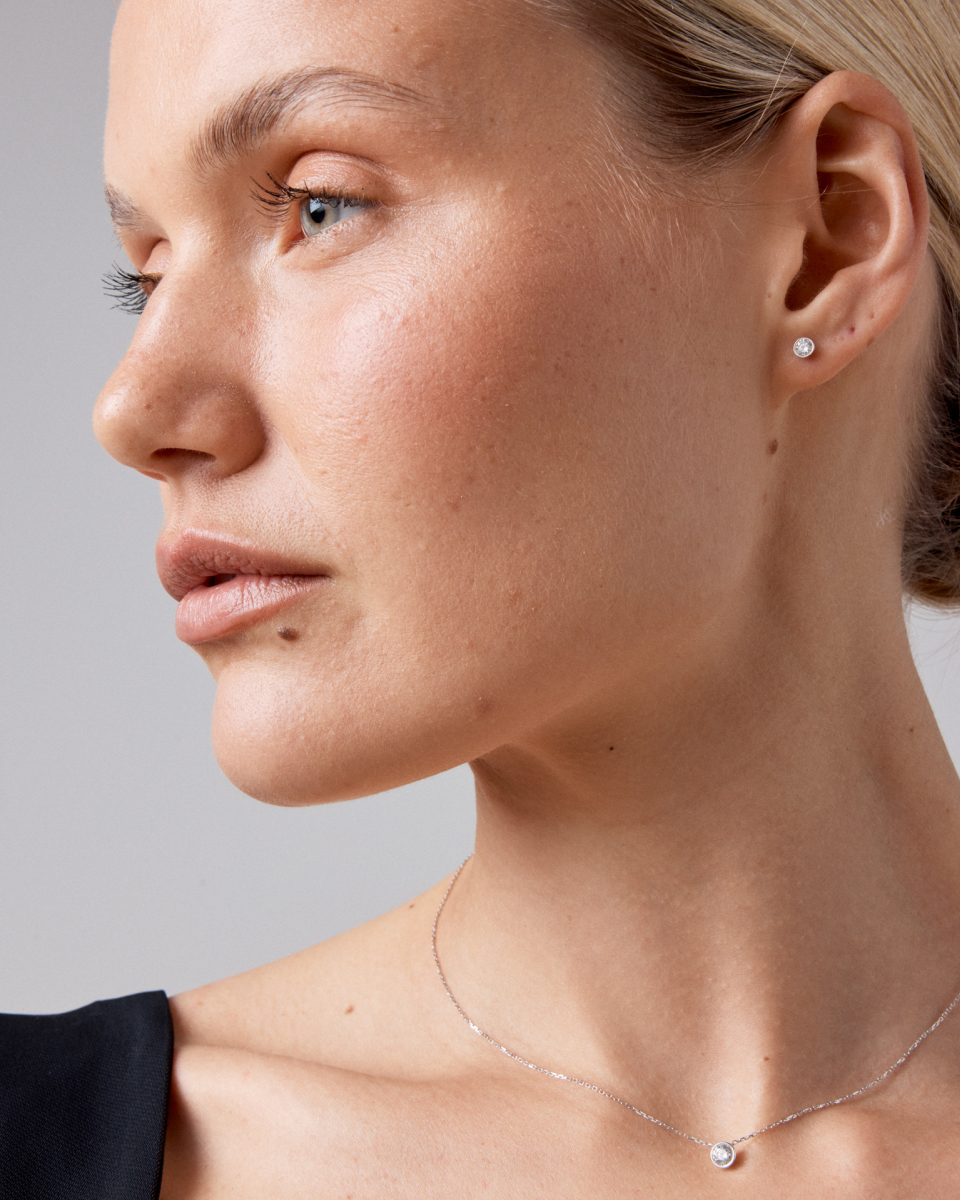 Close up of model wearing a bezel engagement ring 