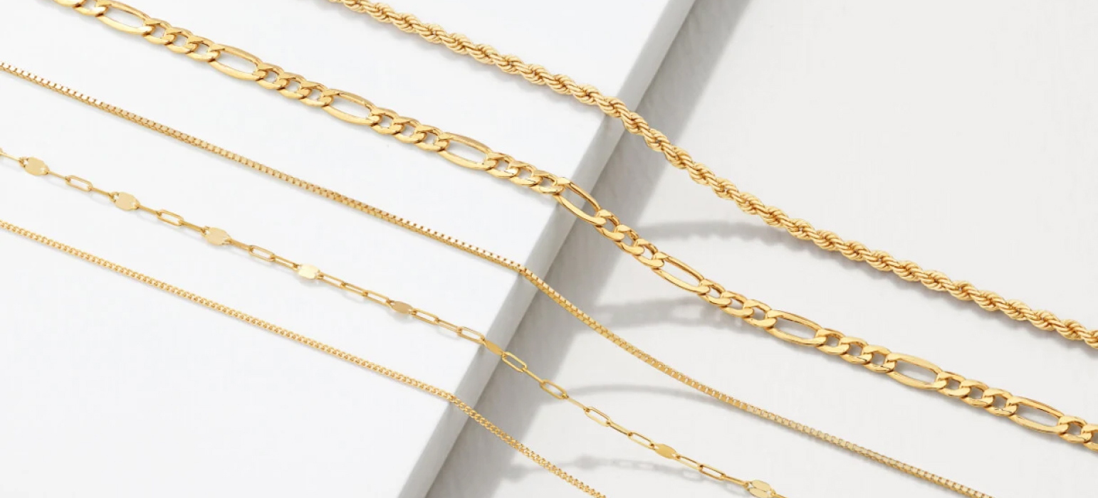 5 gold chains in a variety of styles such as rope, paperclip and belcher