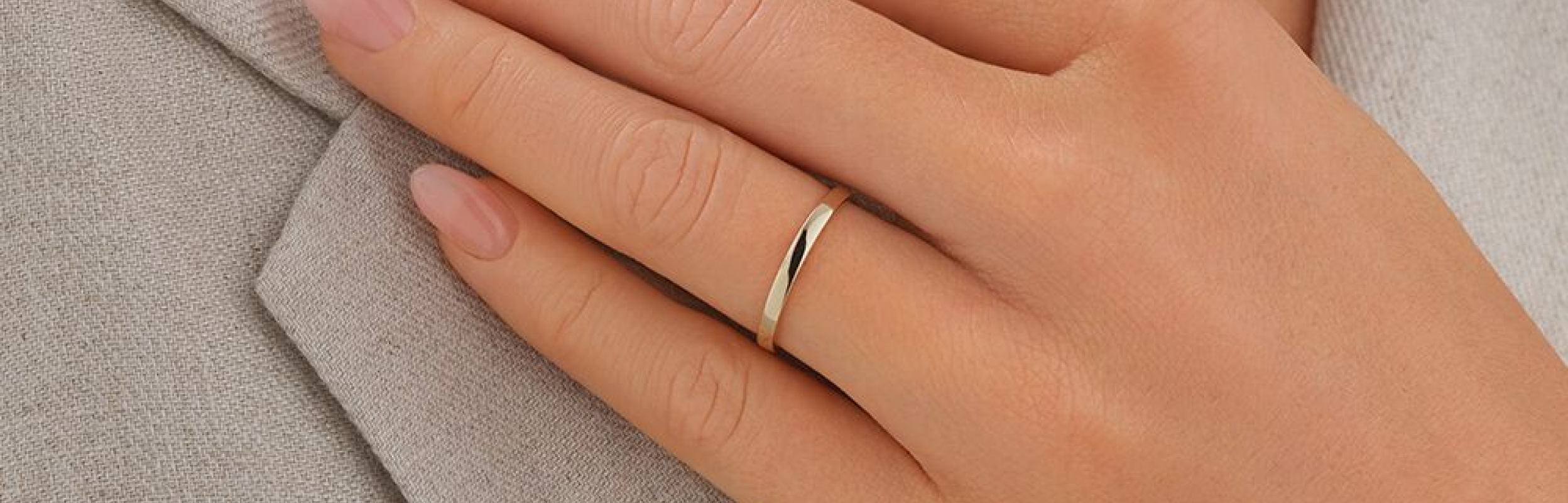 yellow gold wedding ring on womans hand