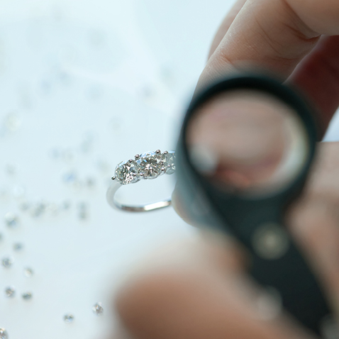 Inspection d'une bague de fiançailles à triple pierre