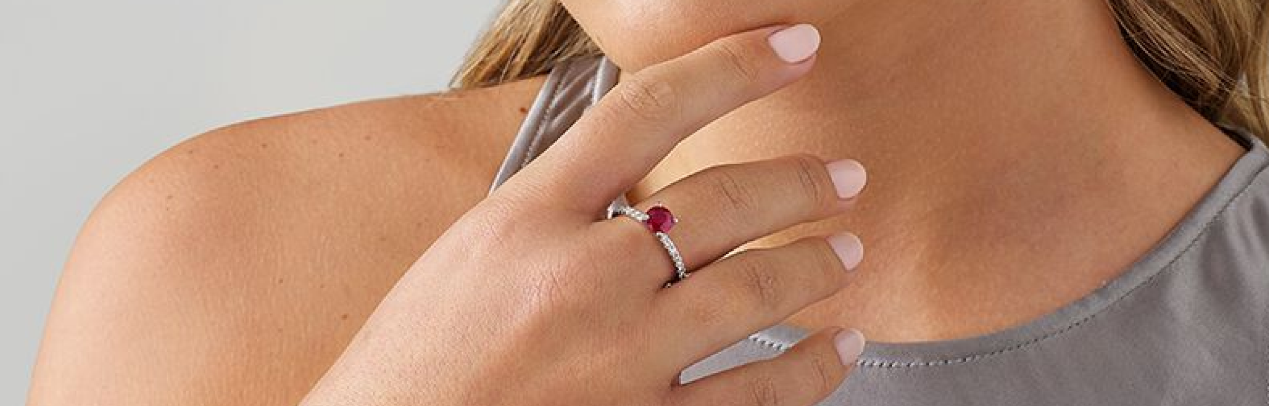 red ruby ring on womans hand