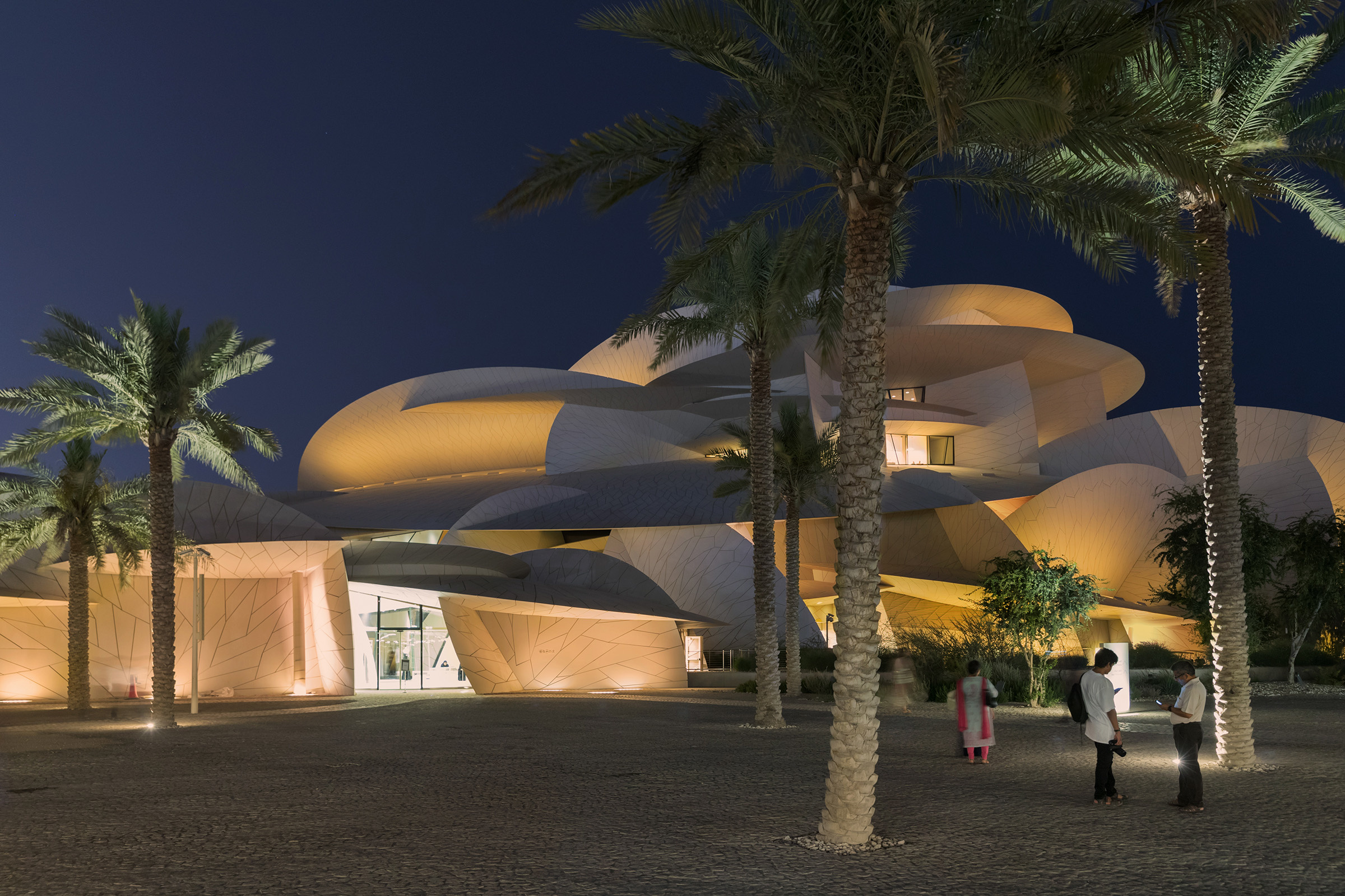 Beautifully lit modern building with people in foreground