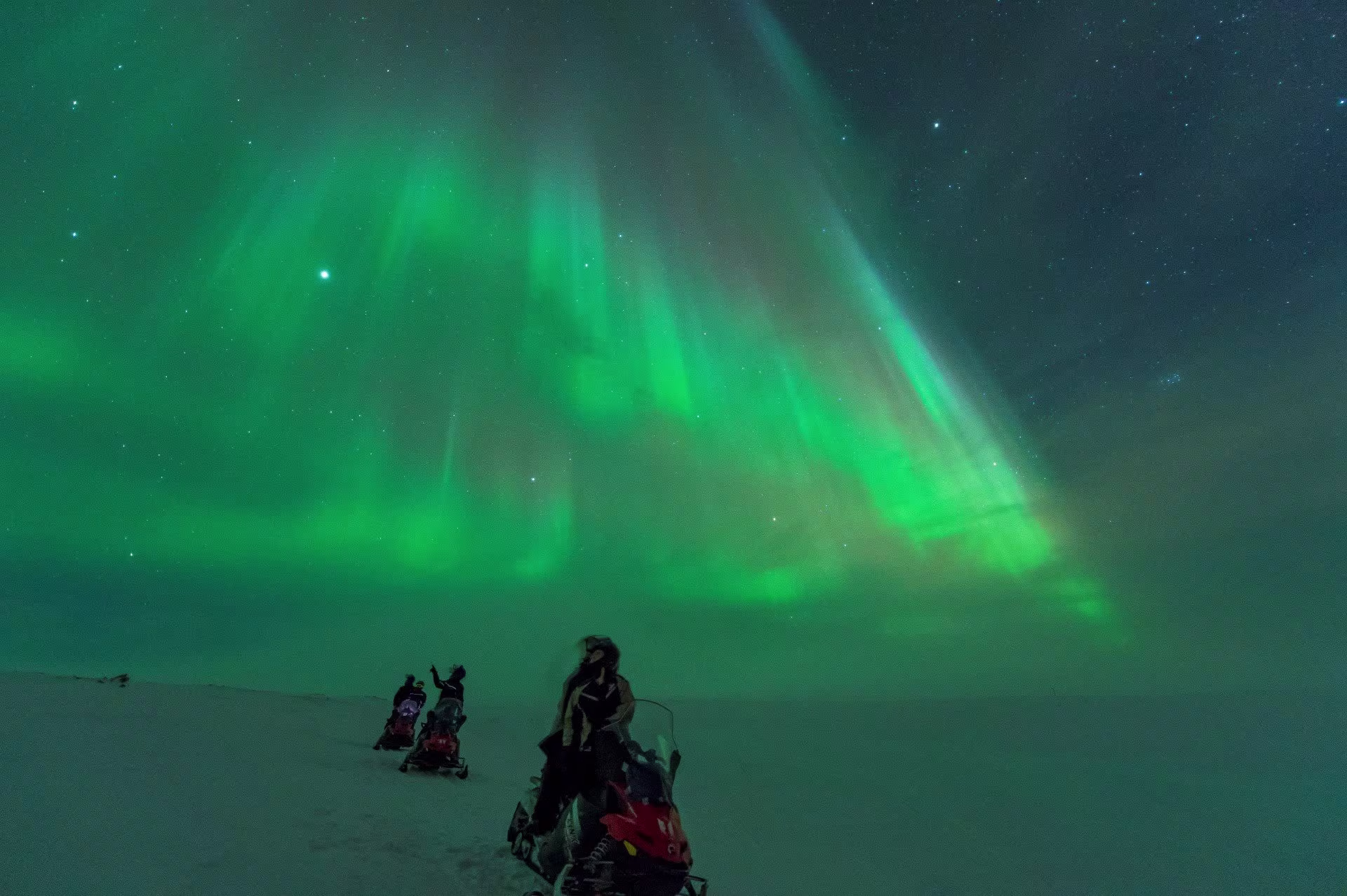 Northern lights, winter and snowmobil