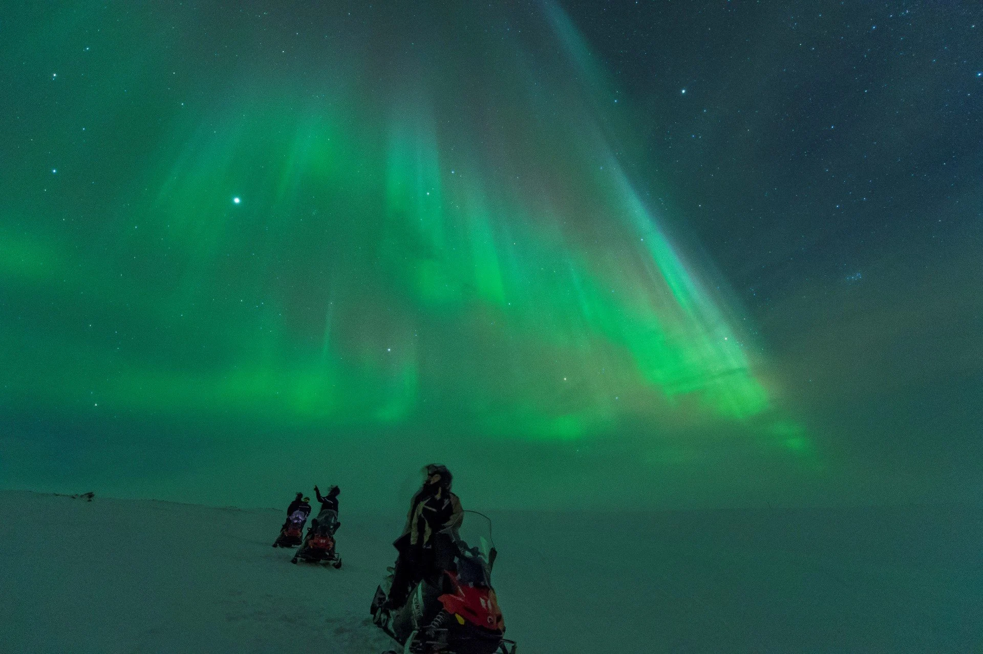 Northern lights, winter and snowmobil