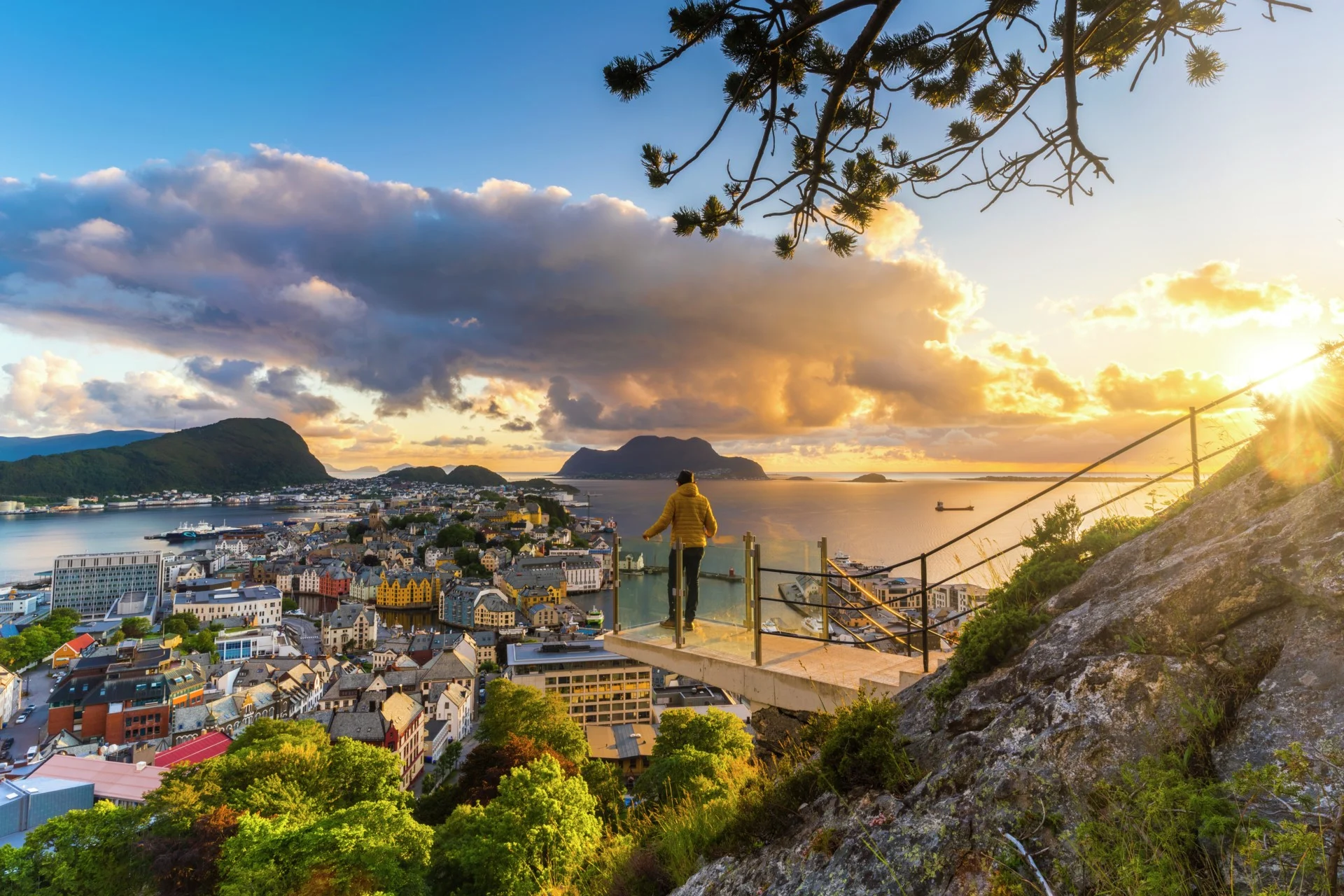 Man looks out over the Art Nuveau city of Ålesund, Norway.