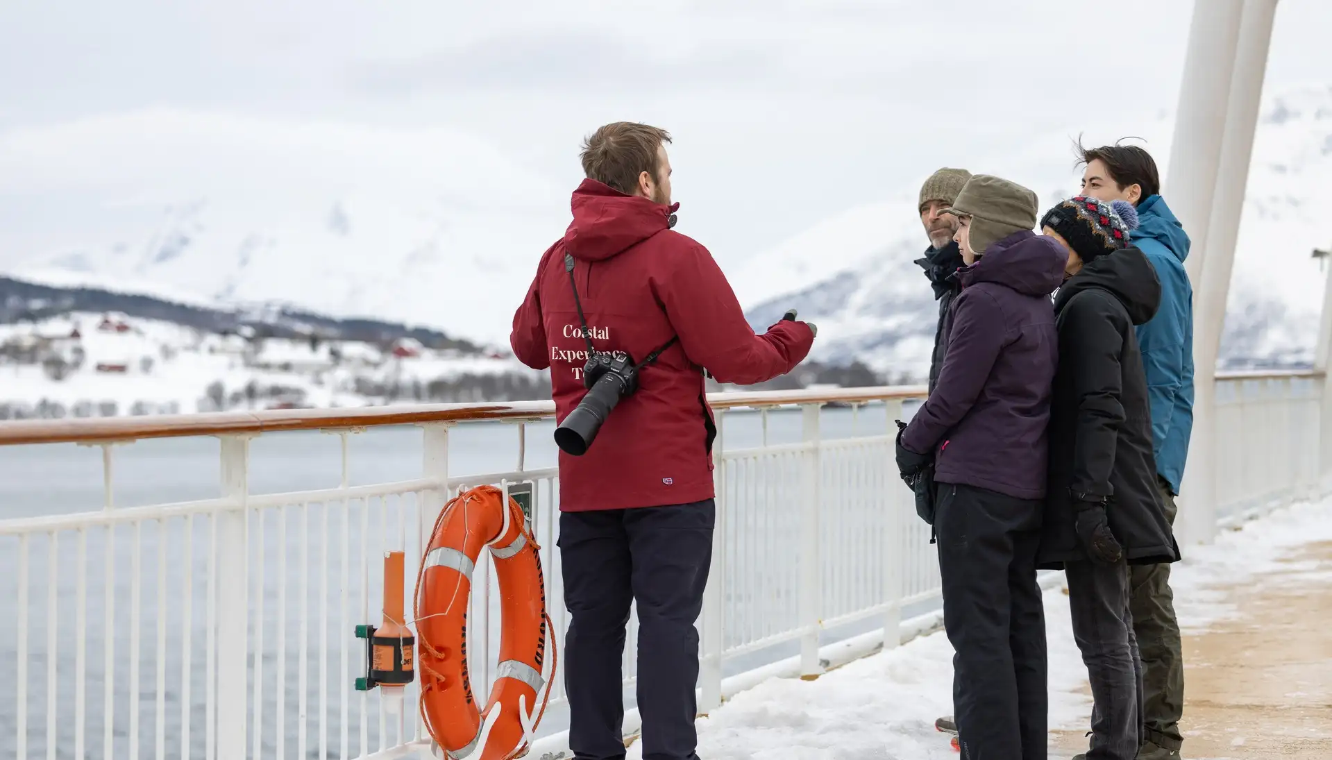 Hurtigruten Costal Experience Team member interacts with guests on deck
