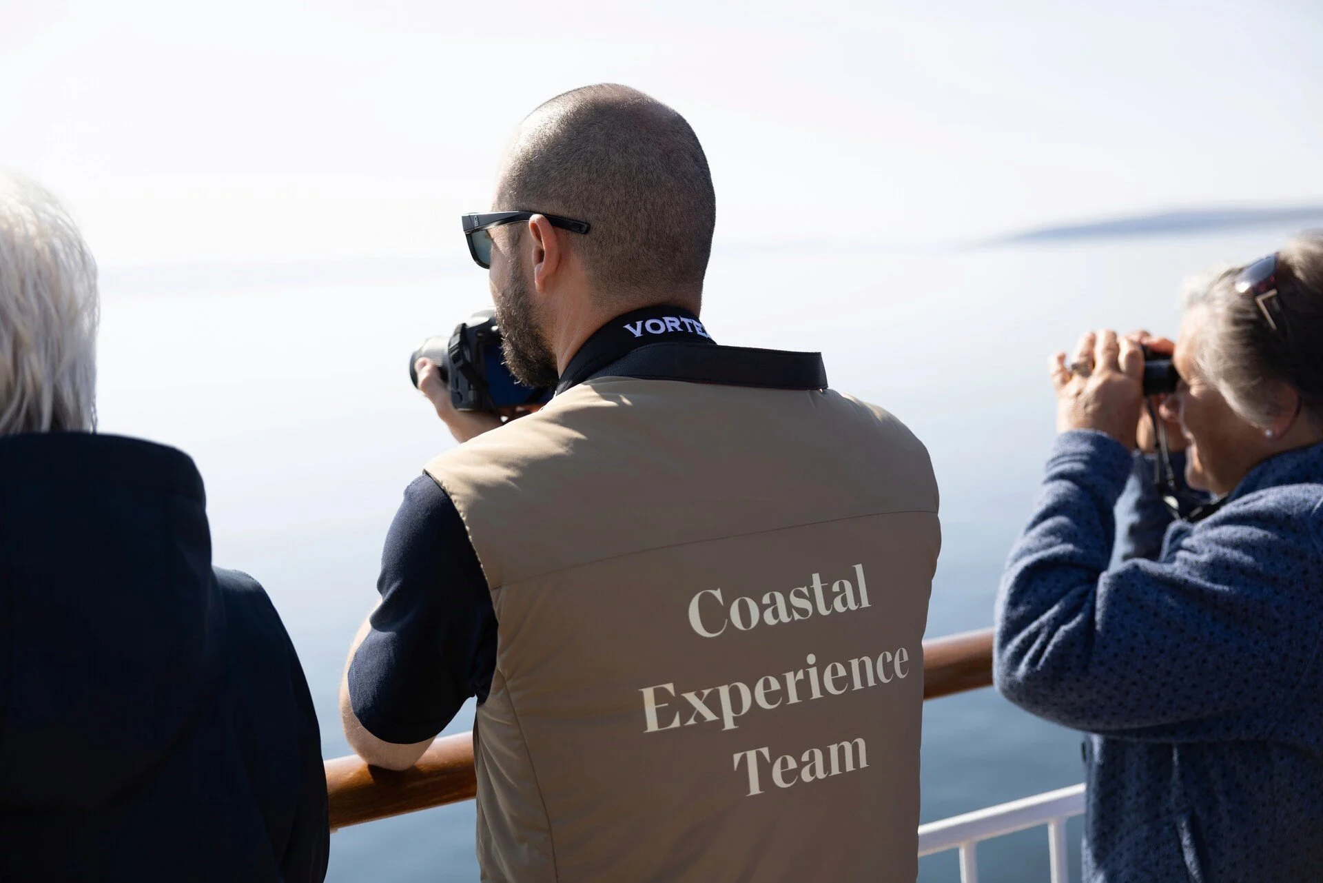 A member of the Coastal Experience Team on deck on a Hurtigruten ship