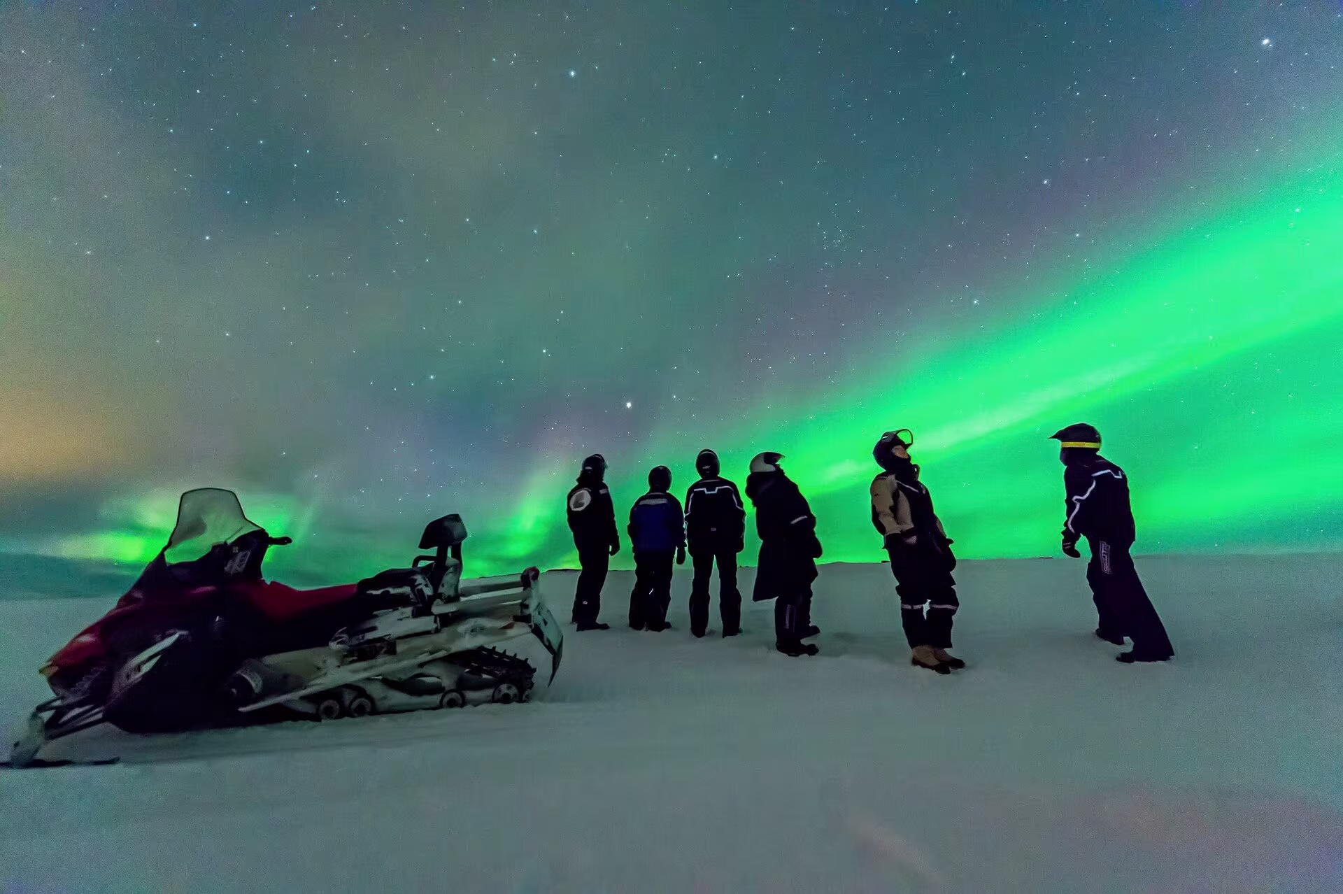 Witness the wonder of the aurora borealis after travelling by snowmobile on a Hurtigruten excursion