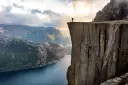 A person looking out from Preikestolen viewpoint in Lysefjord, Stavanger