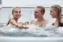 A group of friends relax in the hot tub on board Hurtigruten ship, MS Otto Sverdrup