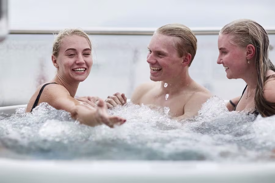 A group of friends relax in the hot tub on board Hurtigruten ship, MS Otto Sverdrup
