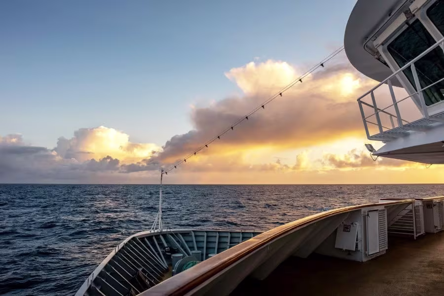 MS Otto Sverdrup sailing along the Norwegian coast at sunset