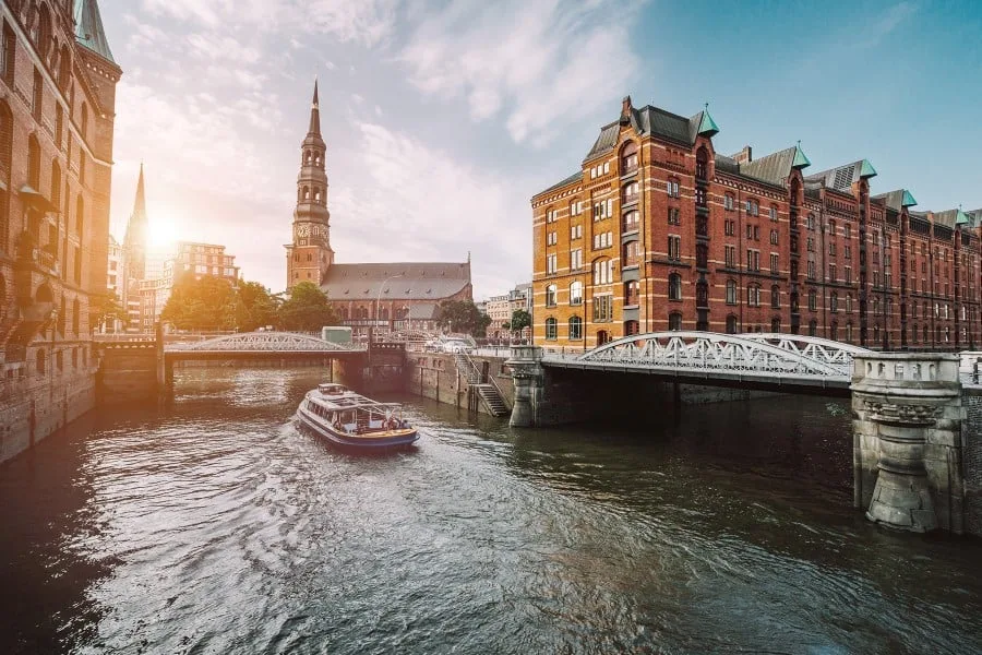 A boat sailing down a canal in Hamburg, Germany