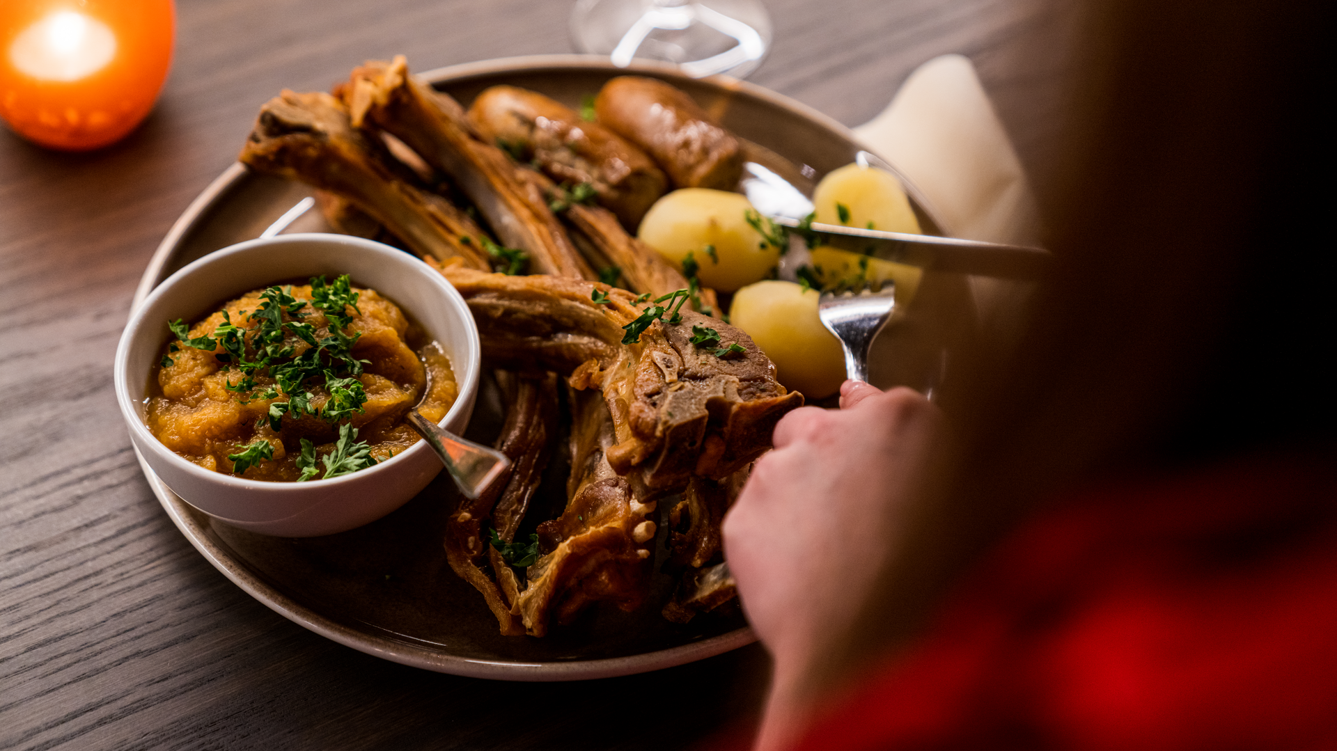 A traditional Christmas dinner of Pinnekjøtt (lamb ribs) served with boiled potatoes. Image copyright: Fredrik Ahlsen - Visit Norway